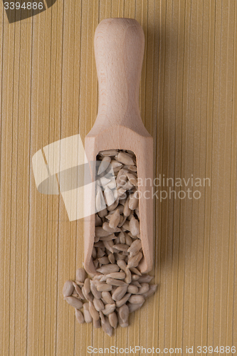 Image of Wooden scoop with shelled sunflower seeds