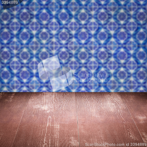 Image of Wood table top and blur vintage ceramic tile pattern wall