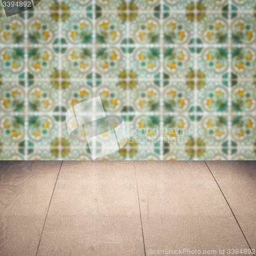 Image of Wood table top and blur vintage ceramic tile pattern wall