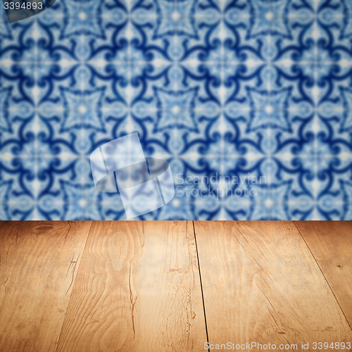 Image of Wood table top and blur vintage ceramic tile pattern wall