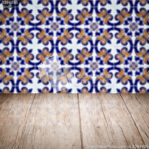 Image of Wood table top and blur vintage ceramic tile pattern wall