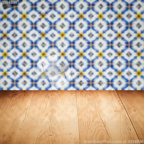 Image of Wood table top and blur vintage ceramic tile pattern wall
