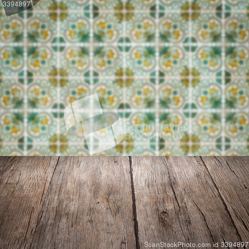 Image of Wood table top and blur vintage ceramic tile pattern wall