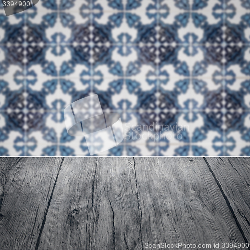 Image of Wood table top and blur vintage ceramic tile pattern wall