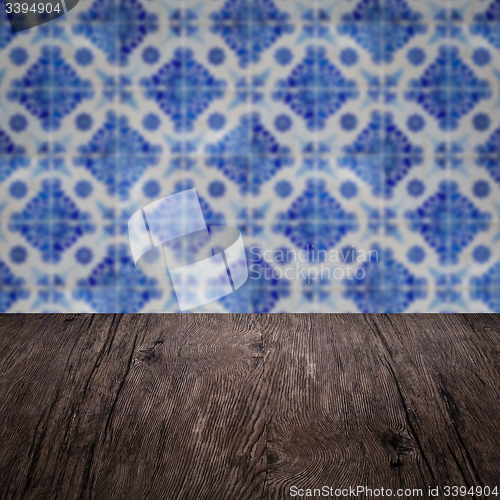 Image of Wood table top and blur vintage ceramic tile pattern wall