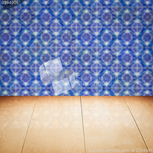 Image of Wood table top and blur vintage ceramic tile pattern wall