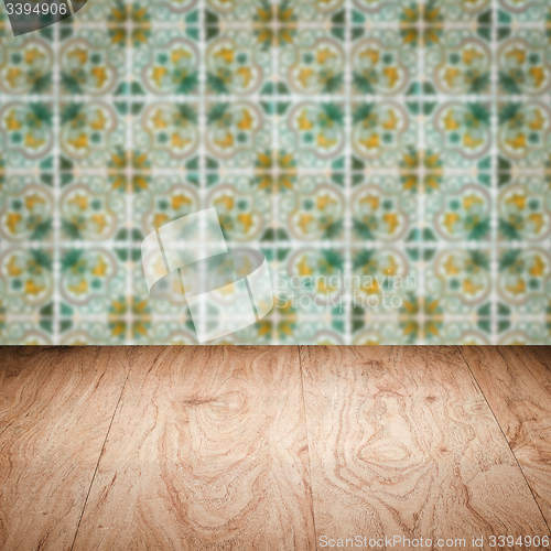 Image of Wood table top and blur vintage ceramic tile pattern wall