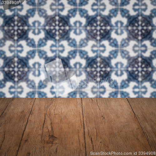 Image of Wood table top and blur vintage ceramic tile pattern wall
