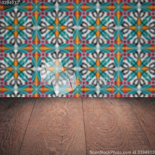 Image of Wood table top and blur vintage ceramic tile pattern wall