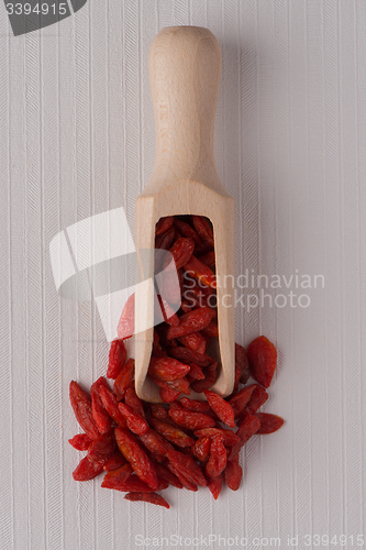 Image of Wooden scoop with dry red goji berries