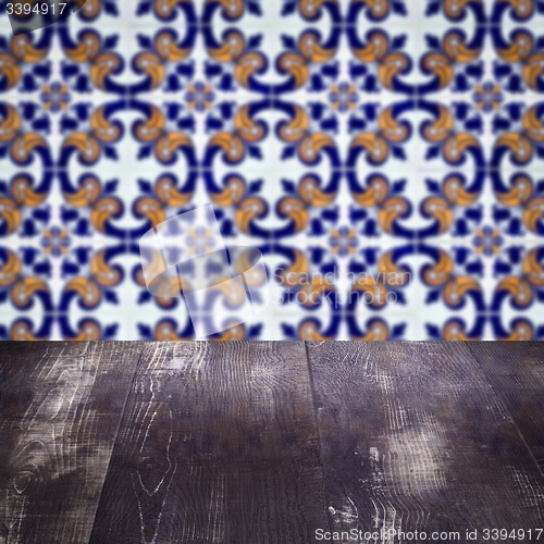 Image of Wood table top and blur vintage ceramic tile pattern wall