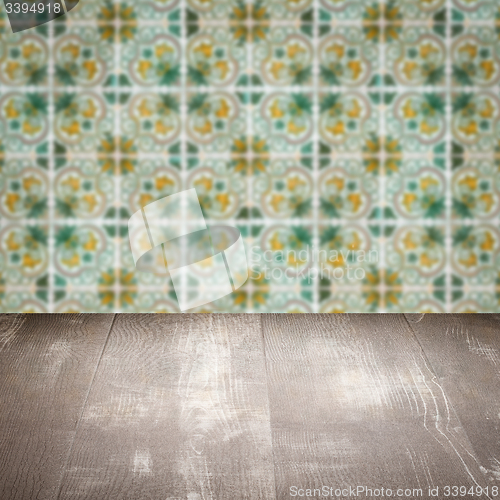 Image of Wood table top and blur vintage ceramic tile pattern wall