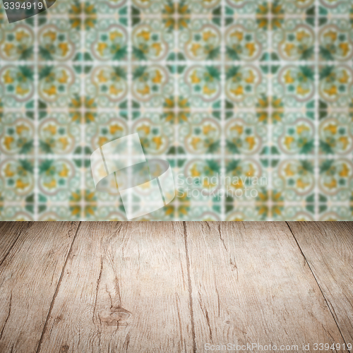 Image of Wood table top and blur vintage ceramic tile pattern wall
