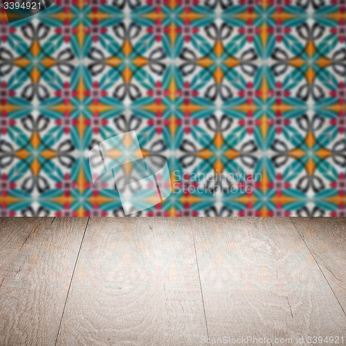 Image of Wood table top and blur vintage ceramic tile pattern wall