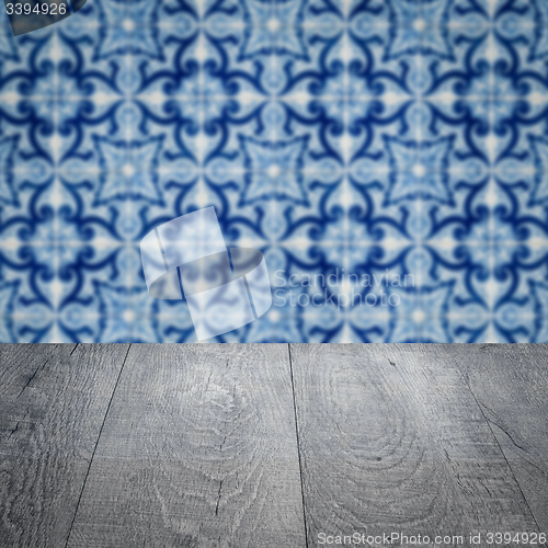 Image of Wood table top and blur vintage ceramic tile pattern wall