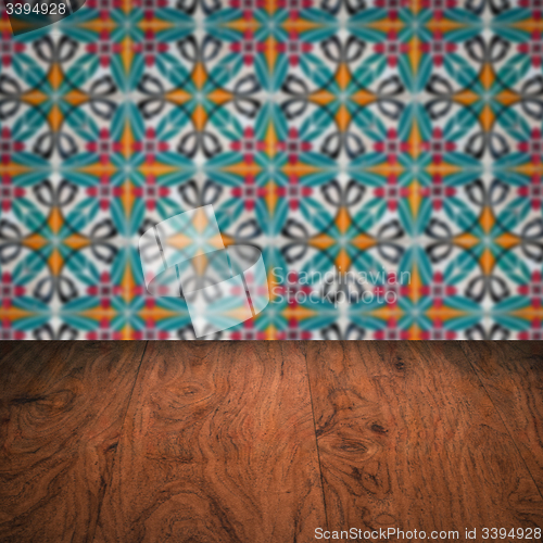 Image of Wood table top and blur vintage ceramic tile pattern wall