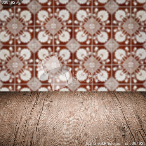 Image of Wood table top and blur vintage ceramic tile pattern wall