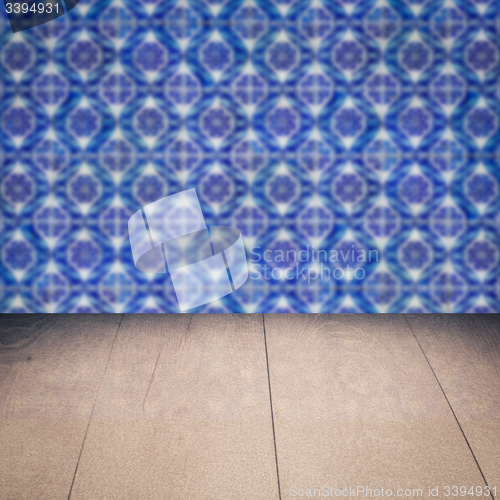 Image of Wood table top and blur vintage ceramic tile pattern wall