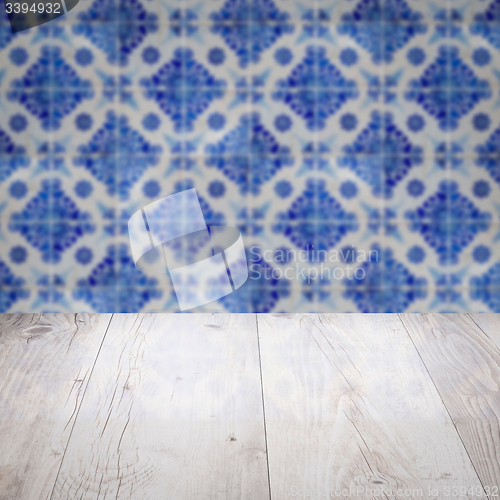 Image of Wood table top and blur vintage ceramic tile pattern wall