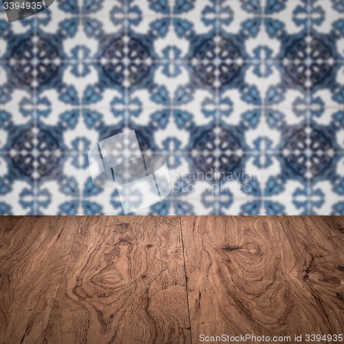 Image of Wood table top and blur vintage ceramic tile pattern wall