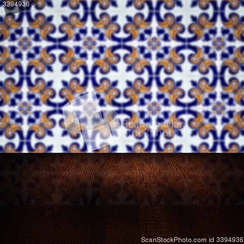 Image of Wood table top and blur vintage ceramic tile pattern wall