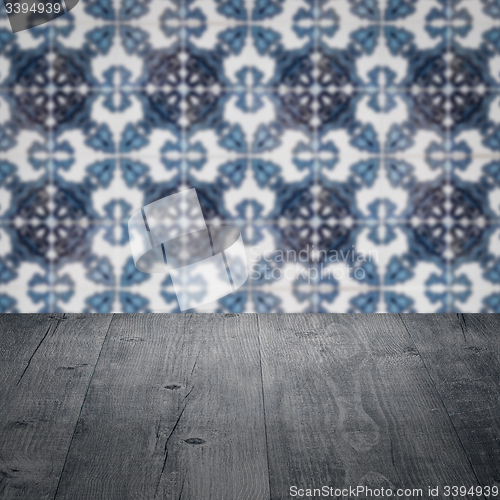 Image of Wood table top and blur vintage ceramic tile pattern wall