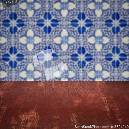 Image of Wood table top and blur vintage ceramic tile pattern wall