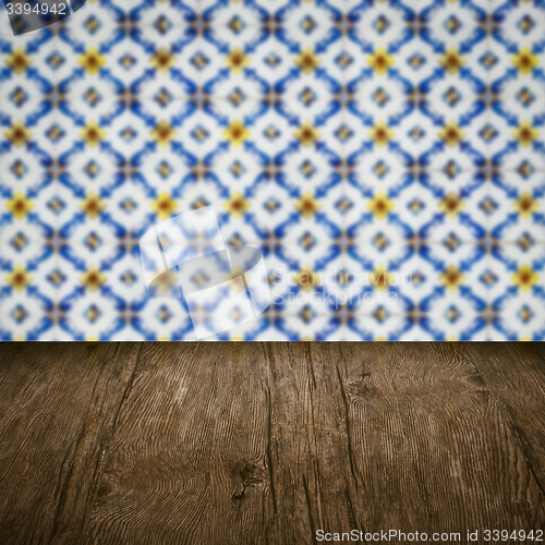 Image of Wood table top and blur vintage ceramic tile pattern wall