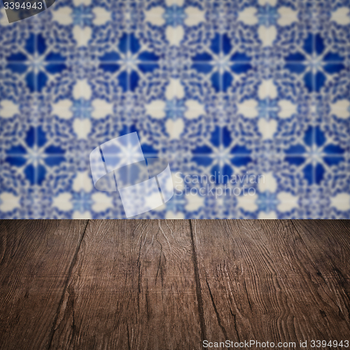 Image of Wood table top and blur vintage ceramic tile pattern wall