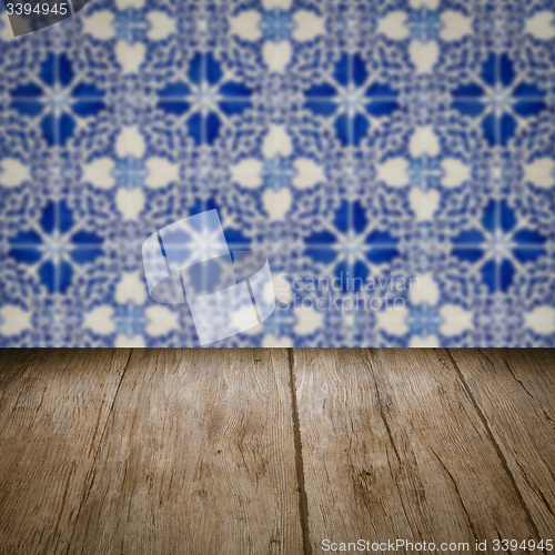 Image of Wood table top and blur vintage ceramic tile pattern wall