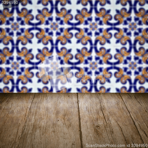 Image of Wood table top and blur vintage ceramic tile pattern wall
