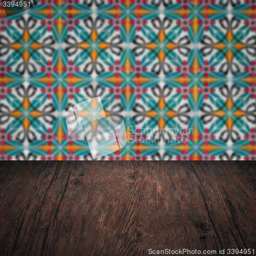 Image of Wood table top and blur vintage ceramic tile pattern wall