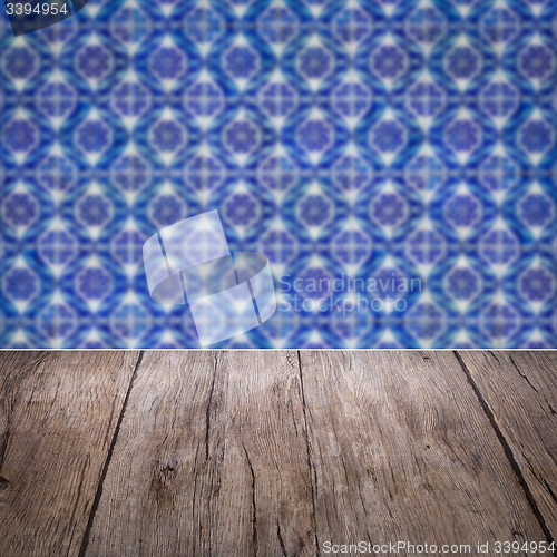 Image of Wood table top and blur vintage ceramic tile pattern wall