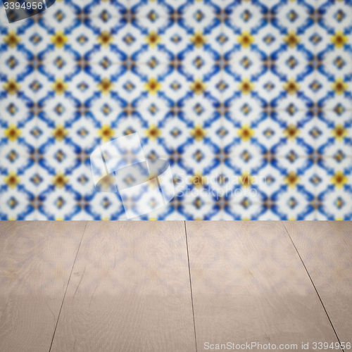 Image of Wood table top and blur vintage ceramic tile pattern wall