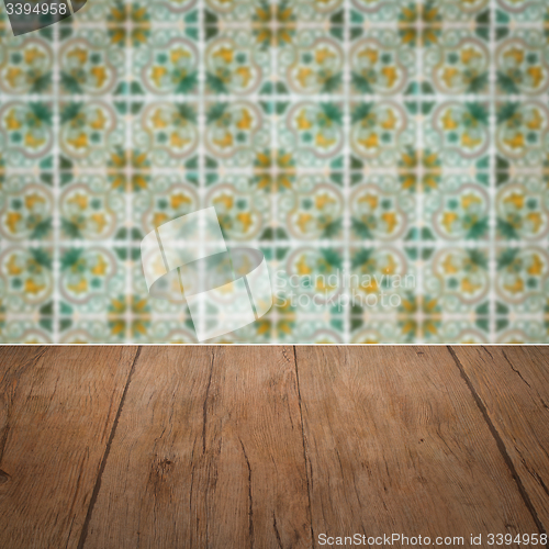 Image of Wood table top and blur vintage ceramic tile pattern wall