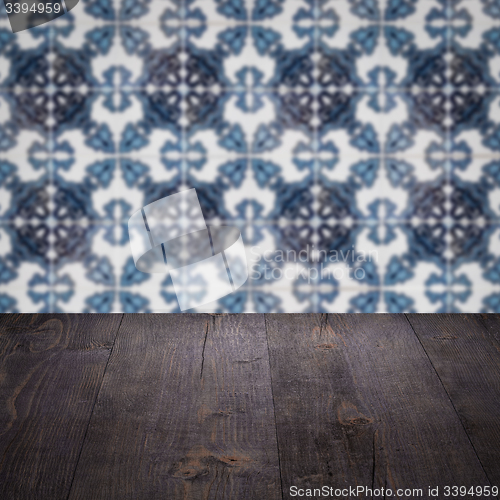 Image of Wood table top and blur vintage ceramic tile pattern wall