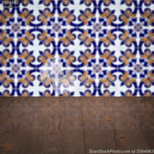 Image of Wood table top and blur vintage ceramic tile pattern wall