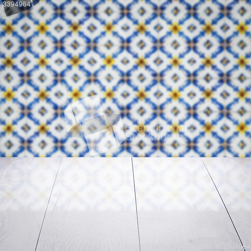 Image of Wood table top and blur vintage ceramic tile pattern wall