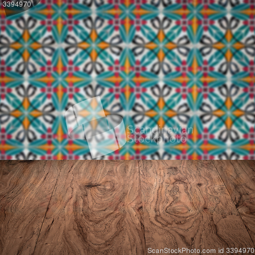 Image of Wood table top and blur vintage ceramic tile pattern wall