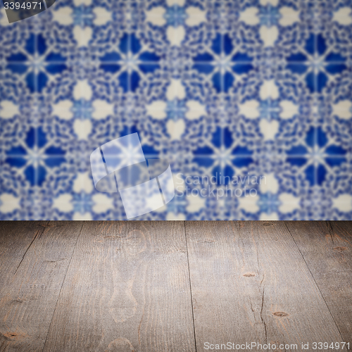 Image of Wood table top and blur vintage ceramic tile pattern wall