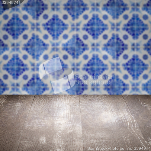 Image of Wood table top and blur vintage ceramic tile pattern wall