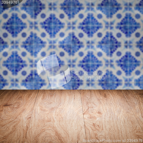 Image of Wood table top and blur vintage ceramic tile pattern wall