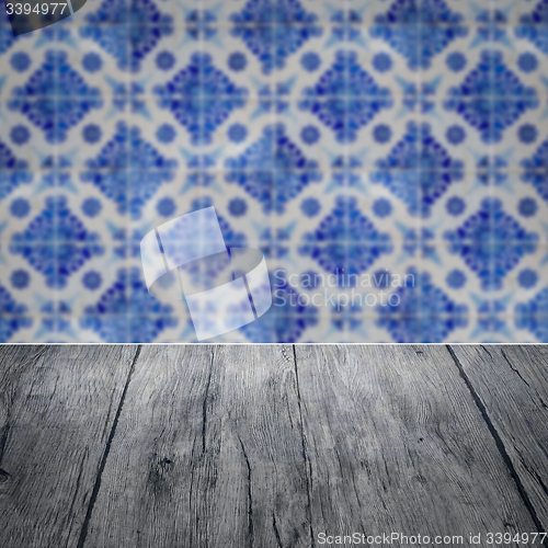 Image of Wood table top and blur vintage ceramic tile pattern wall