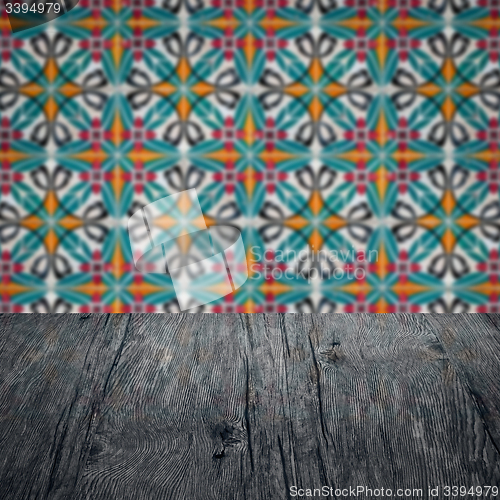 Image of Wood table top and blur vintage ceramic tile pattern wall