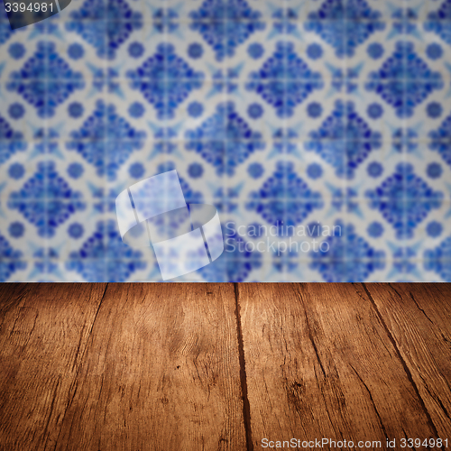 Image of Wood table top and blur vintage ceramic tile pattern wall