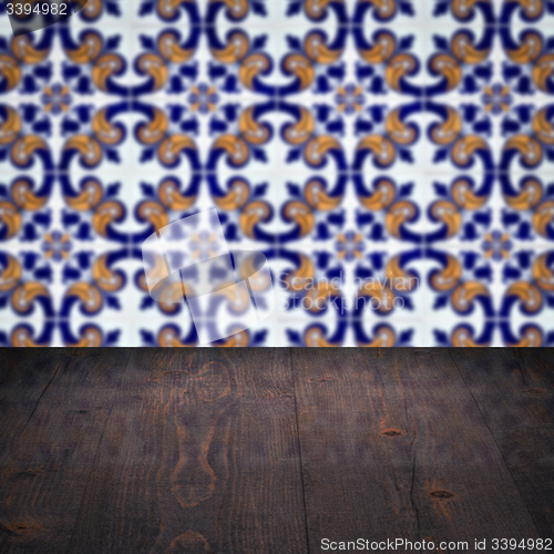 Image of Wood table top and blur vintage ceramic tile pattern wall