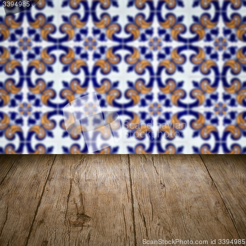 Image of Wood table top and blur vintage ceramic tile pattern wall