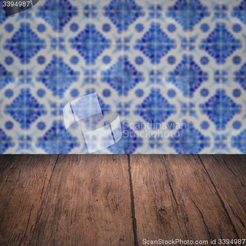 Image of Wood table top and blur vintage ceramic tile pattern wall