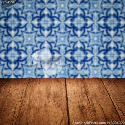 Image of Wood table top and blur vintage ceramic tile pattern wall