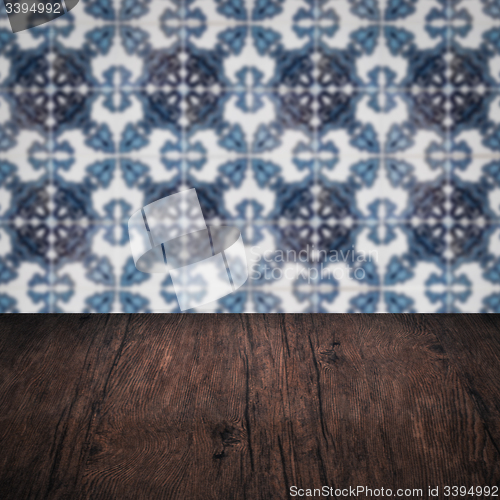 Image of Wood table top and blur vintage ceramic tile pattern wall